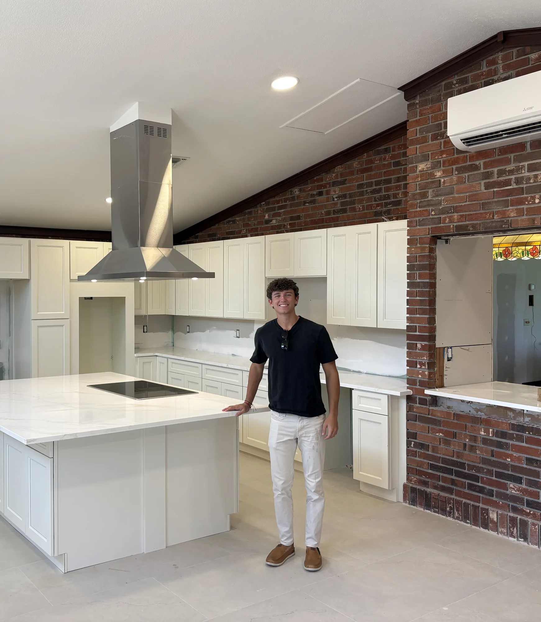 Glenn Dagher Jr. at an Orlando job, cabinets and countertops in, backsplash still to come.